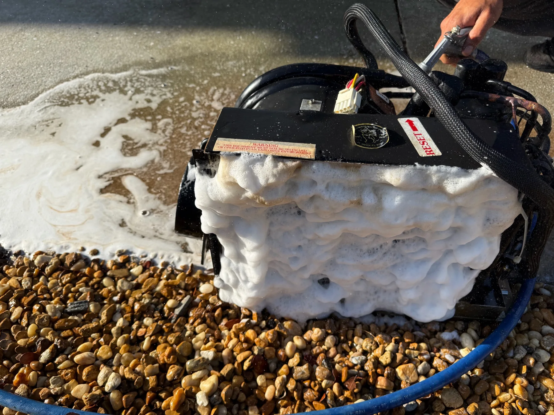 Self-contained marine air-conditioning unit covered with foaming cleaner during service