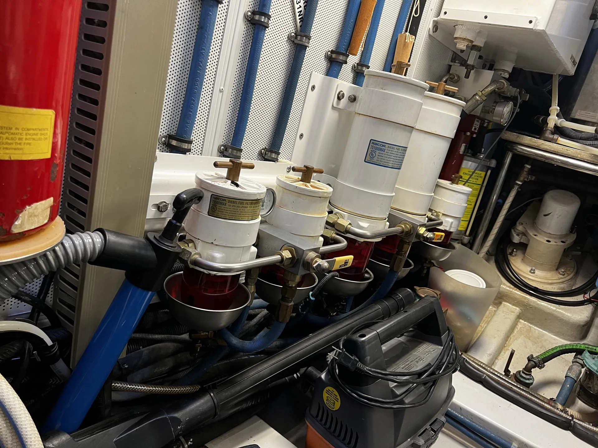 Multiple Racor fuel-filter water separators installed in a marine engine room