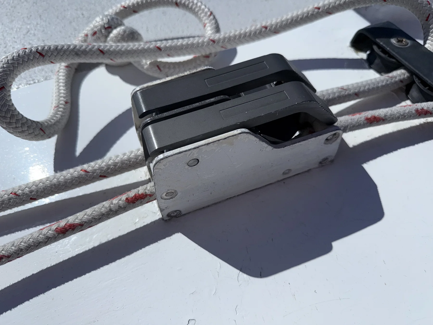 Dual rope clutch installed on a sailboat deck with two control lines